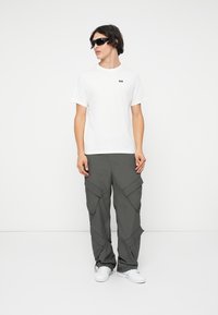 Helly Hansen CORE GRAPHIC UNISEX - Triko s potiskem - white