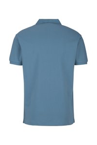 Korte mouwen polo shirt van lichtblauwe katoen. Voorzien van een klassieke kraag en een rechte zoom met minimale stikdetails.