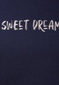 Navy fabric t-shirt featuring white text "SWEET DREAMS" in a textured, hand-written style across the chest area.
