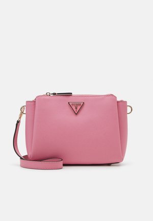 Pink Guess crossbody bag with textured finish, a triangular logo plaque, and a detachable strap with gold hardware.