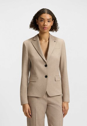 Tan tailored blazer with a smooth texture, notched lapels, two black buttons, and a subtle logo on the chest pocket.