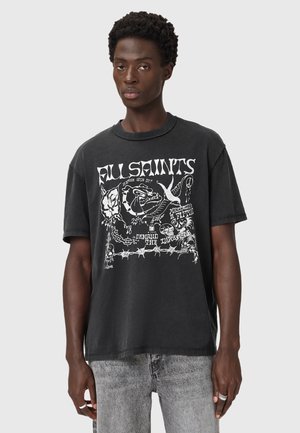 T-shirt noir oversize avec impression graphique présentant divers motifs en blanc, manches courtes, col en rib et texture douce en coton.