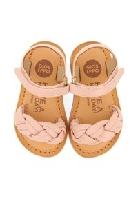 Sandalias de piel de color rosa claro con un diseño trenzado en la parte delantera y suela plana. Cuentan con correas en el tobillo ajustables y acolchado interno con marca.