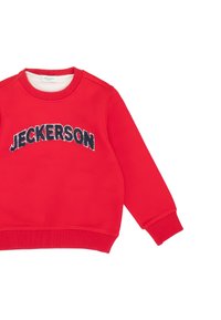 Red sweatshirt made of soft fabric, featuring a round neck and ribbed cuffs. The word "JECKERSON" is prominently displayed in black lettering.