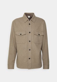 Bruine, gestructureerde overhemd met knopen en een kraag, twee borstzakken en zwarte knopen. Lange mouwen met manchetknopen.