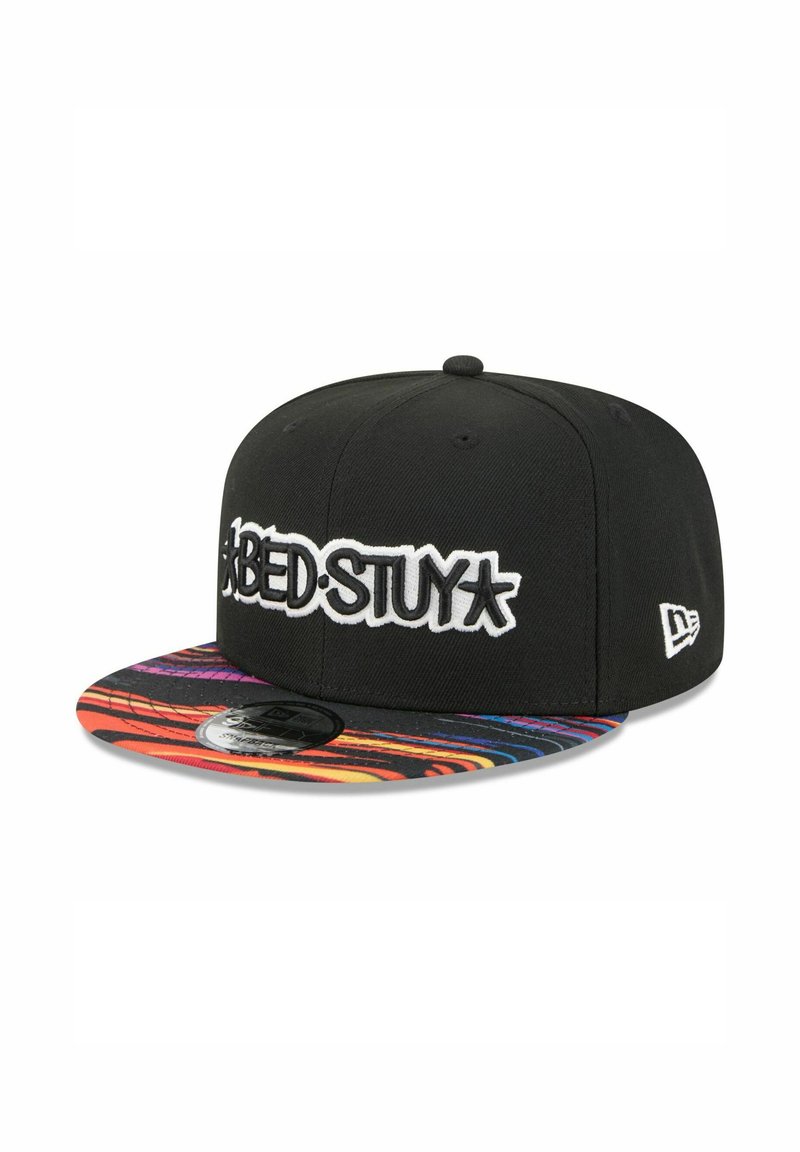 Black snapback cap with white embroidered "BED-STUY" logo and a vibrant, multi-colored patterned brim featuring curved lines.