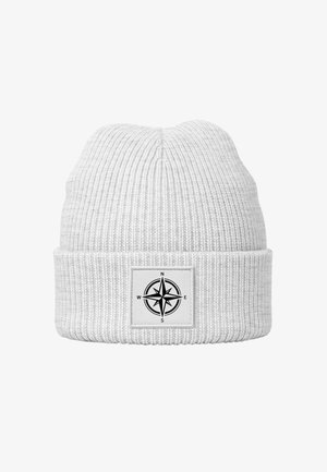 White knit beanie with a ribbed texture, featuring a black compass patch on a white background. Simple, functional design.
