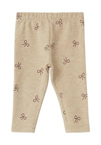 Beige legging van zacht stof met een herhalend patroon van kleine donkerpaarse strikjes. Elastische tailleband en nauwsluitend model.