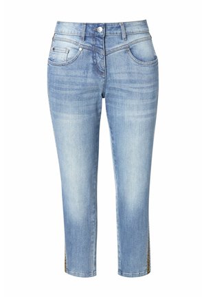 Jean en denim bleu clair avec un design ajusté, longueur cropped et ouvertures latérales ornées de quincaillerie décorative. Texture lisse avec décoloration.