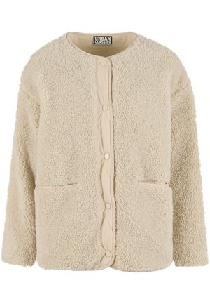 Crèmekleurig fleecejack met een gestructureerde buitenkant, ronde halslijn en twee zakken aan de voorkant. Drukknopen als sluiting en gewatteerde voering aan de binnenkant.