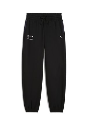 Pantalons de jogging noirs en tissu doux, avec une taille élastique et des poignets élastiques, ornés de détails de marque blancs sur le devant et sur le côté.