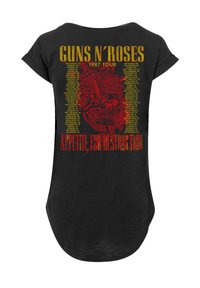 Schwarzes T-Shirt mit rotem Totenschädel- und Schlangengrafik, gelbem Text "Guns N' Roses 1987 Tour" sowie einer Liste von Tourstädten in Gelb und Rot.