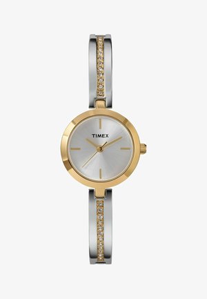 Timex-Uhr mit einem runden Gehäuse in Silber, einer Lünette in Gold, einem silbernen Zifferblatt, goldenen Akzenten und einem Armband mit klaren Kristallelementen.