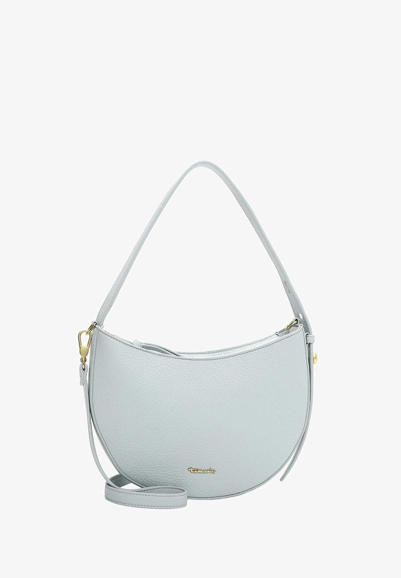 Světle šedá kožená kabelka s oblým tvarem, horním zapínáním na zip a nastavitelným ramenním popruhem. Ozdobena zlatým logem.