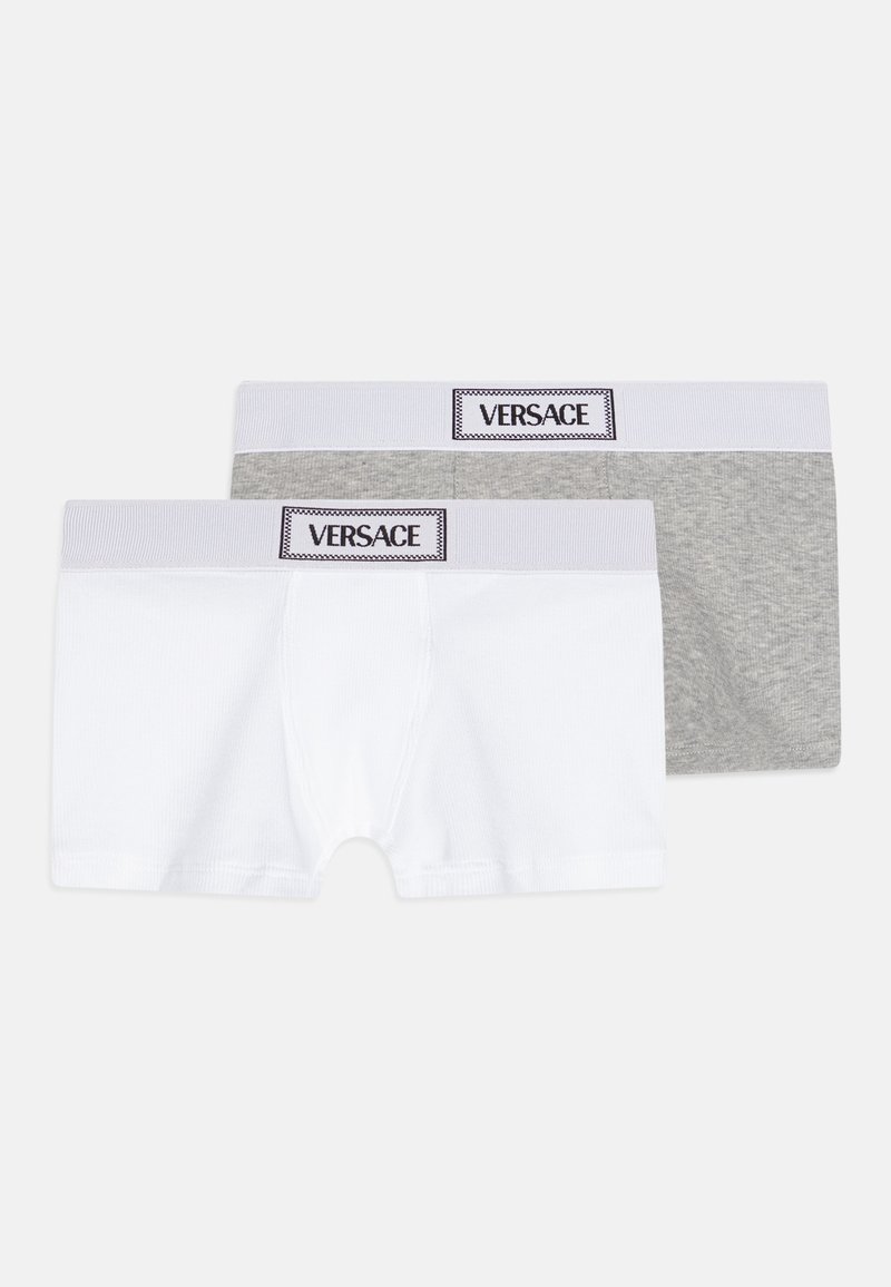 Two pairs of boxer shorts: one white, one gray. Both feature a soft ribbed texture and elastic waistband with "VERSACE" logo.