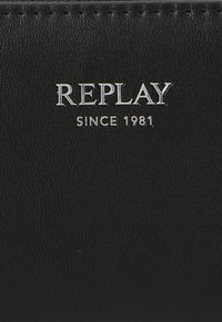 Czarny portfel wykonany z teksturowanej skóry, z metalowym logo "REPLAY" i detalem "SINCE 1981" wytłoczonym z przodu.