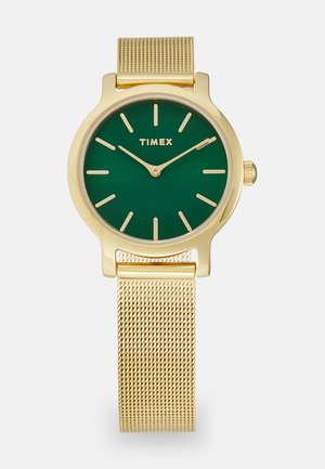 Goudkleurige Timex-horloge met een groene wijzerplaat, minimalistische indexmarkeringen en een mesh armband. Cirkelvormige kast met slank profiel en kroon.