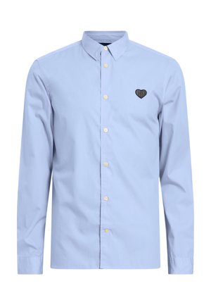 Lichtblauwe longsleeve shirt van katoen, met een button-down kraag en een zwart hartvormig geborduurd detail op de borst.