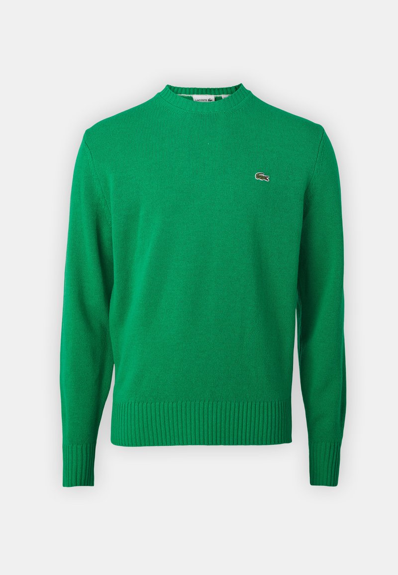 Maglione verde a maglia con collo a coste e orlo, caratterizzato da un piccolo logo ricamato sul petto. Realizzato in un tessuto morbido e strutturato.