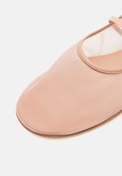 Soft pink ballet flat featuring a smooth fabric upper, rounded toe, and a thin strap along the edge. Flat rubber sole for comfort.