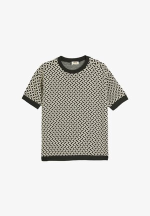 Kortærmet strik T-shirt i sort og creme med et geometrisk mønster, der har en sort ribbede rund halsudskæring og ærmekanter.