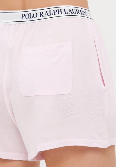 Light pink cotton shorts with a mesh texture, featuring a white waistband labeled "POLO RALPH LAUREN" and a back pocket.