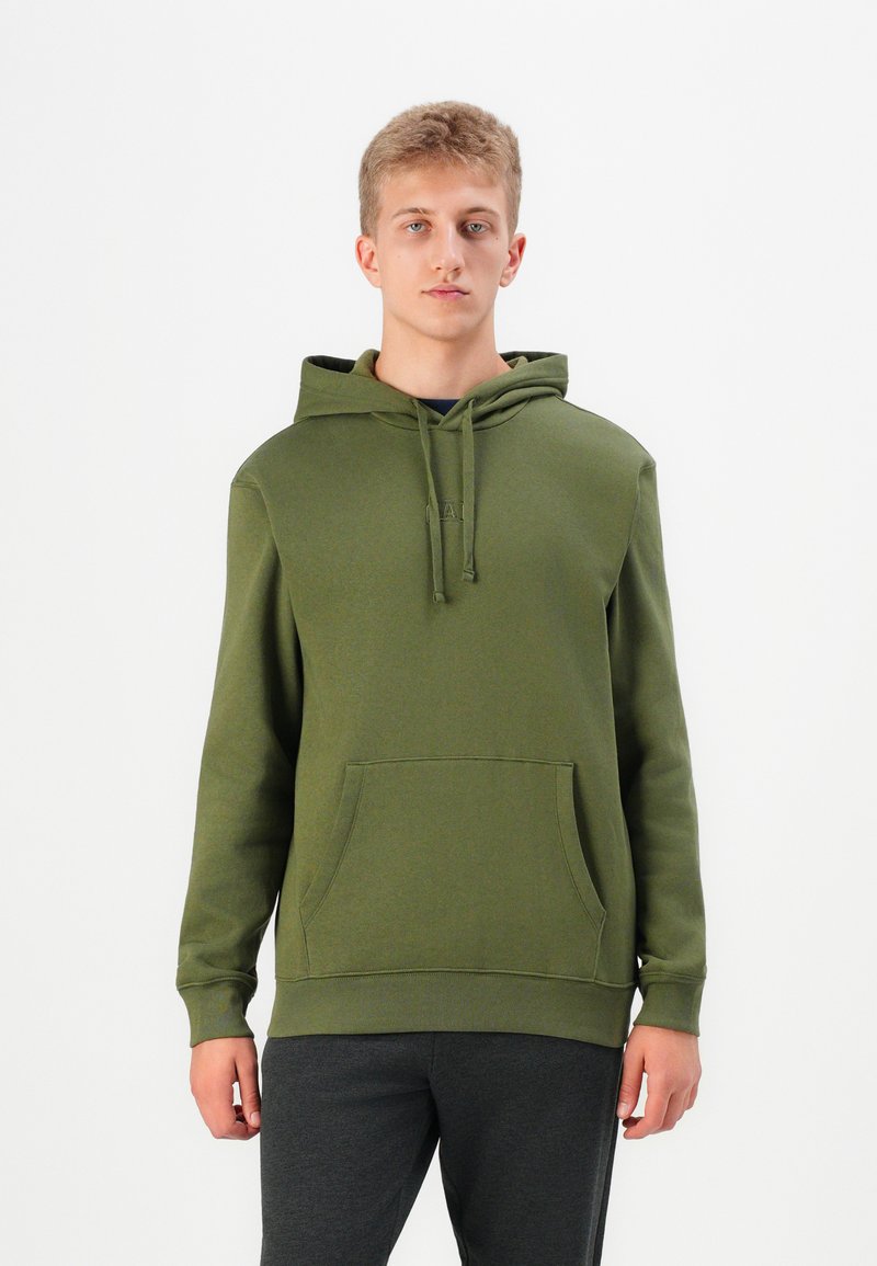 Olive green hoodie made of soft fabric with a kangaroo pocket, drawstrings, ribbed cuffs, and hem; worn with dark gray pants.