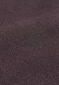 Nahaufnahme eines dunkelvioletten Strickstoffs mit detaillierter Textur und feinem Webmuster.