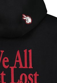 Black hoodie featuring red text "We All Get Lost" on the front and a white peace hand gesture embroidered on the hood.
