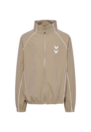 Beige lynlåstrøje med hvide pipinger langs ærmer og skuldre, elastiske manchetter og nederdel samt to hvide chevron-logoer på brystet.