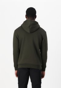 Dark green hoodie with a large, adjustable hood. Cotton blend material, ribbed cuffs, and hem. Simple design with no visible logos.
