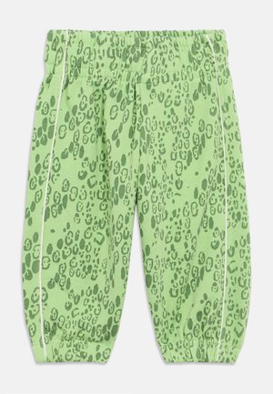 Green patterned pants featuring a leopard print design with a relaxed fit, elastic waistband, and white side accents.