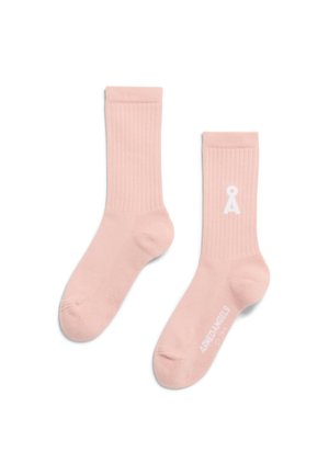 Rosa gerippte Socken aus weichem Material, mit einem weißen Logo und Text an der Seite. Glatte Textur mit enganliegendem Sitz.