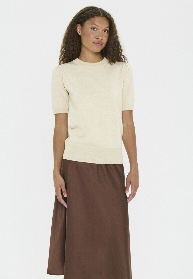 Short-sleeve, cream knitted top with a round neck, complemented by a brown satin midi skirt, featuring a soft texture and relaxed fit.