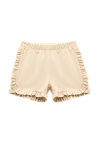 Pantalones cortos beige con acentos de volantes a lo largo de los lados y el dobladillo. Cintura elástica para mayor comodidad. Textura suave con una tela ligera.