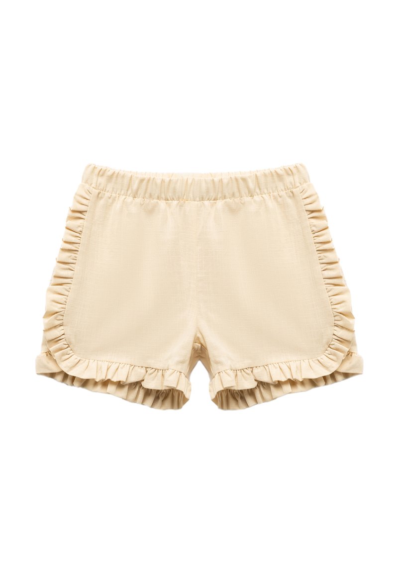 Pantalones cortos beige con acentos de volantes a lo largo de los lados y el dobladillo. Cintura elástica para mayor comodidad. Textura suave con una tela ligera.