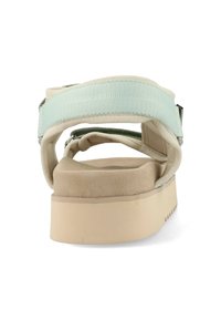 Plateau sandaal met een brede, gestructureerde mintgroene band, zachte beige binnenzool en lichtbruine buitenzool met kleine ribbels.