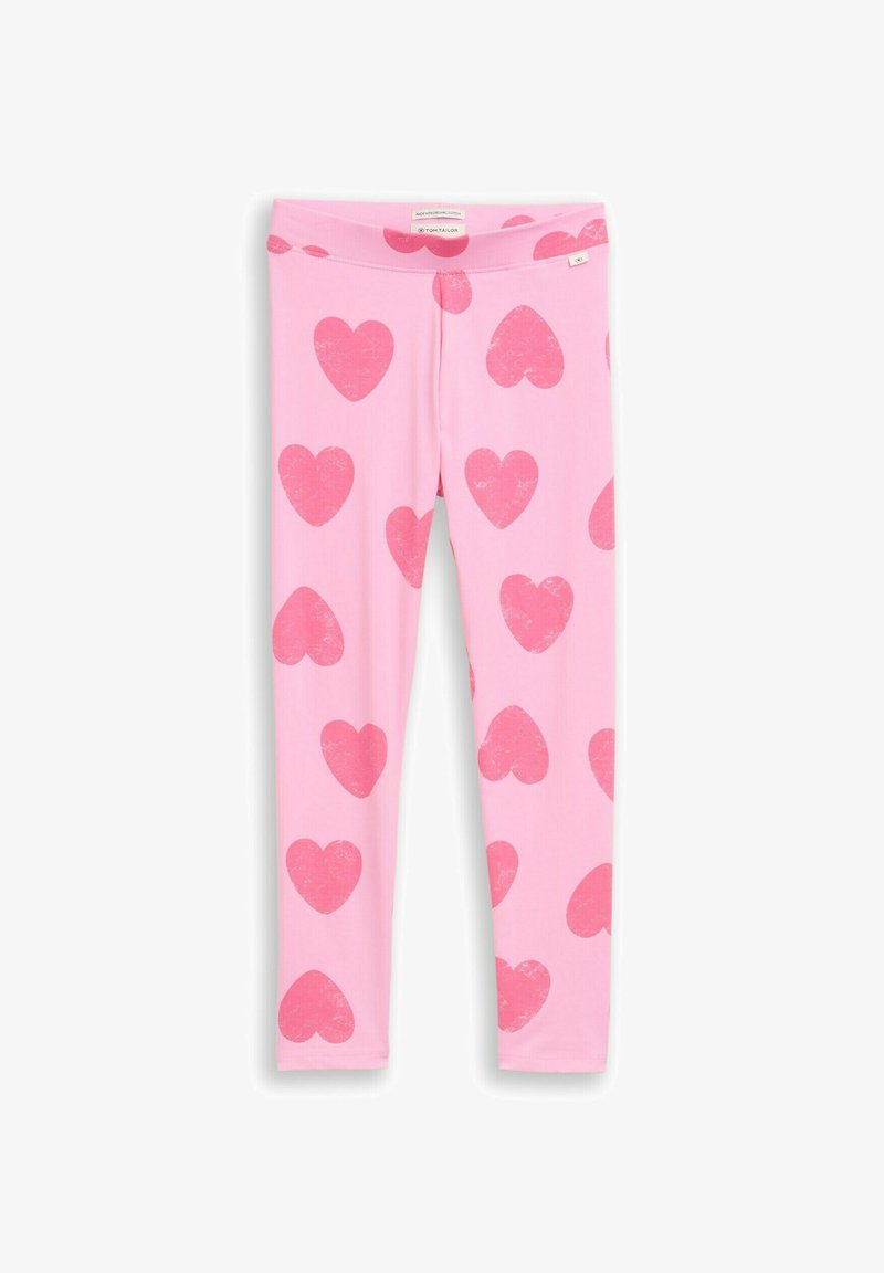 Leggings roses avec de grands motifs en forme de cœur rouges dispersés, en coton biologique, présentés à plat sur un fond blanc.