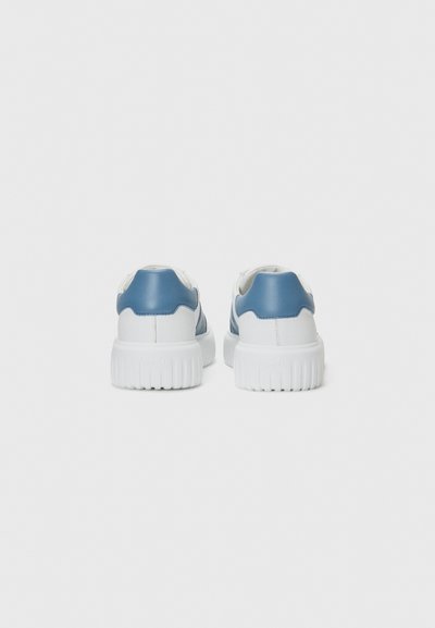 White sneakers with a smooth blue leather accent, rounded shape, ridged white sole, and minimalistic design without visible branding.