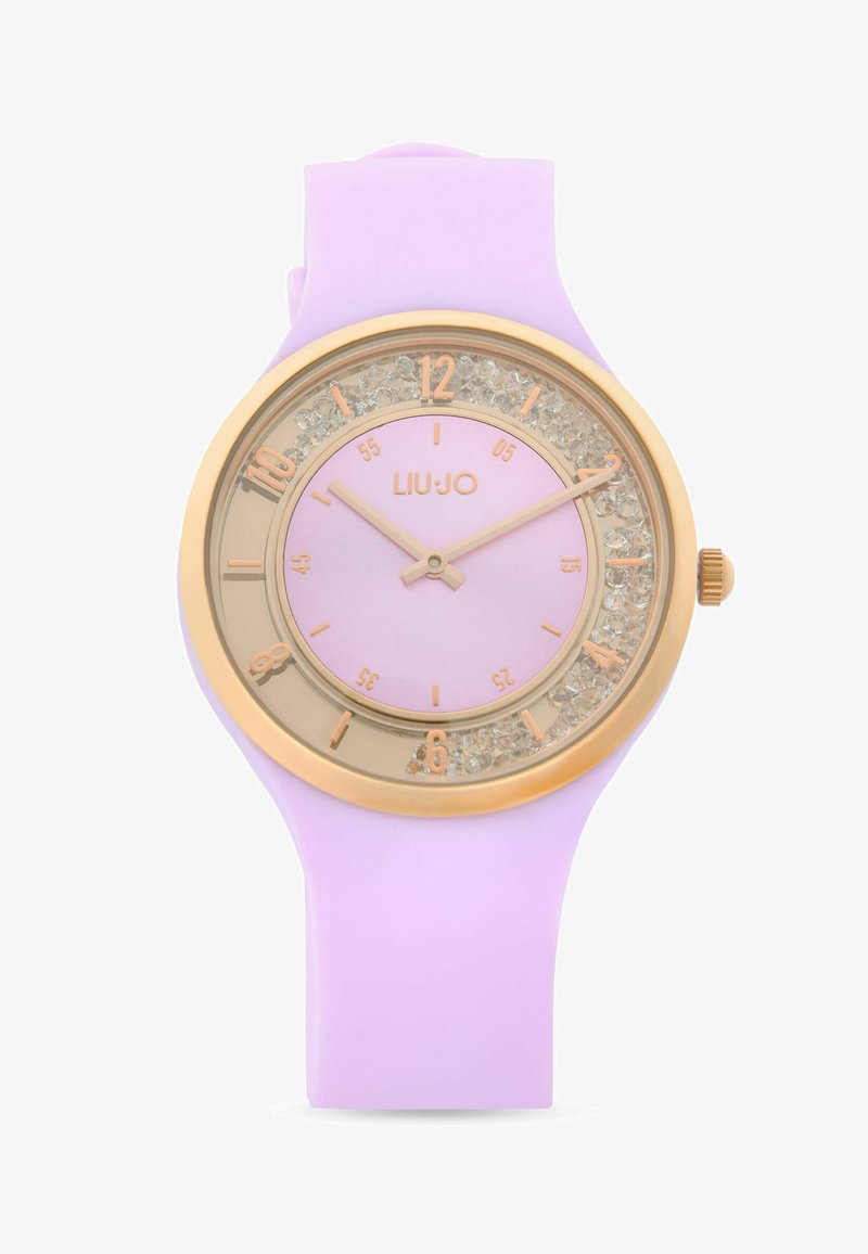 Montre-bracelet à bracelet en silicone lilas avec boîtier rond doré, ornements en cristal, et index ainsi que aiguilles dorés, marque Liu Jo.