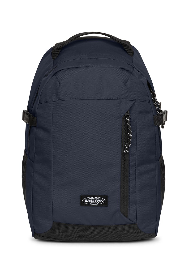 Zaino blu navy con tessuto strutturato, dettagli neri, multiple tasche con cerniera e spallacci regolabili. Presenta il logo del marchio sulla parte anteriore.