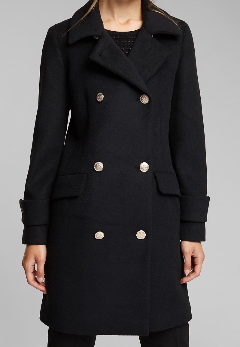 Black wool blend coat with a double-breasted design, metallic buttons, side pockets, and notched lapels. Textured fabric with a tailored fit.