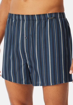 Marineblauwe boxershort met verticale strepen in blauw en grijs. Voorzien van een comfortabele elastische tailleband en een enkele knoopsluiting.