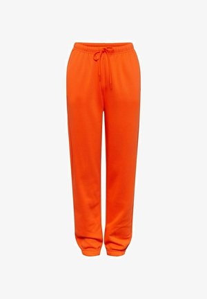 Pantaloni della tuta arancioni realizzati in un tessuto morbido, con vita regolabile tramite cordino e polsini elasticizzati. Design semplice senza motivi o dettagli visibili.