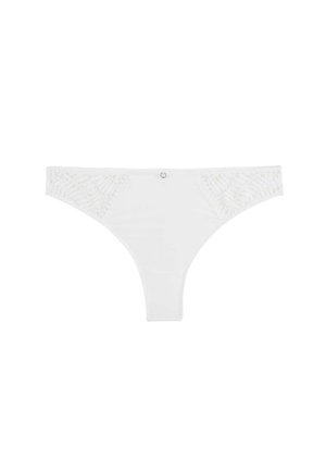 String en dentelle blanche avec côtés transparents à motif de feuilles et un petit charm en métal circulaire au centre avant.