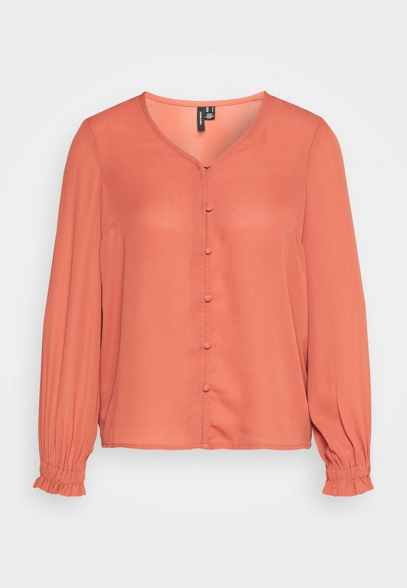 Blouse couleur rouille avec un décolleté en V, manches longues, fermeture à boutons à l'avant et poignets élastiques, fabriquée à partir d'un tissu léger.