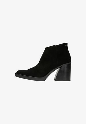 Black suede ankle boot with a pointed toe and a chunky heel featuring a textured accent. The design is sleek with minimal stitching.