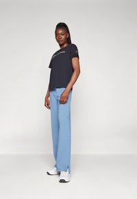 Champion ICONS FLARE PANTS - Παντελόνι φόρμας - blue