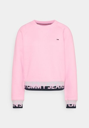 Sweat-shirt rose clair à manches longues, avec poignets et ourlet marine et gris, avec le texte "Tommy Jeans" et un petit logo sur la poitrine.