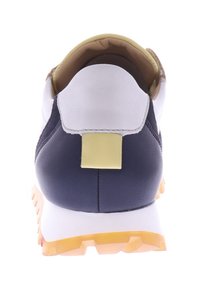 Rear view of athletic shoe featuring white leather, navy sides, yellow accents, and a textured rubber sole with a prominent heel tab.